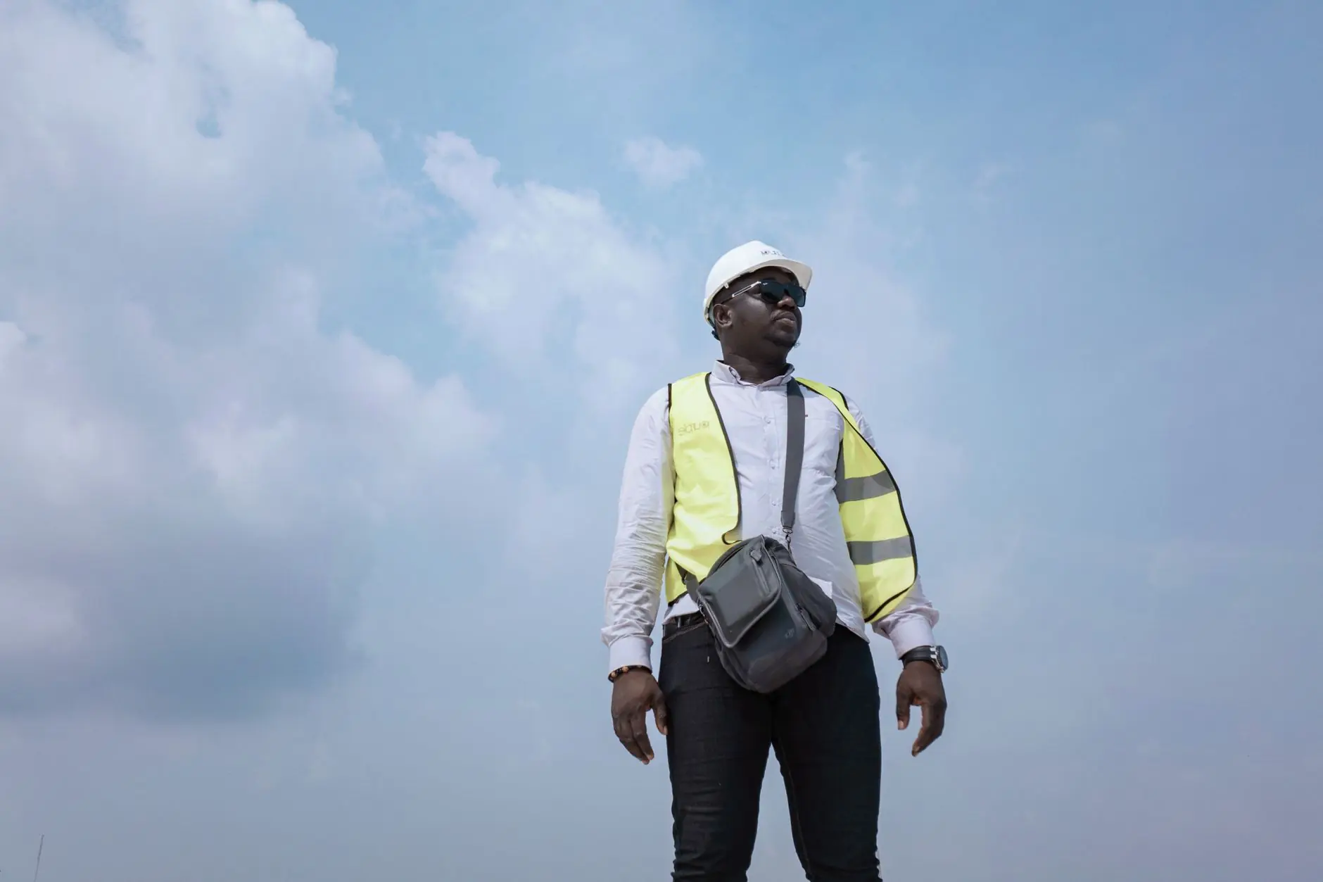 Nigerian engineer in a hard hat on site