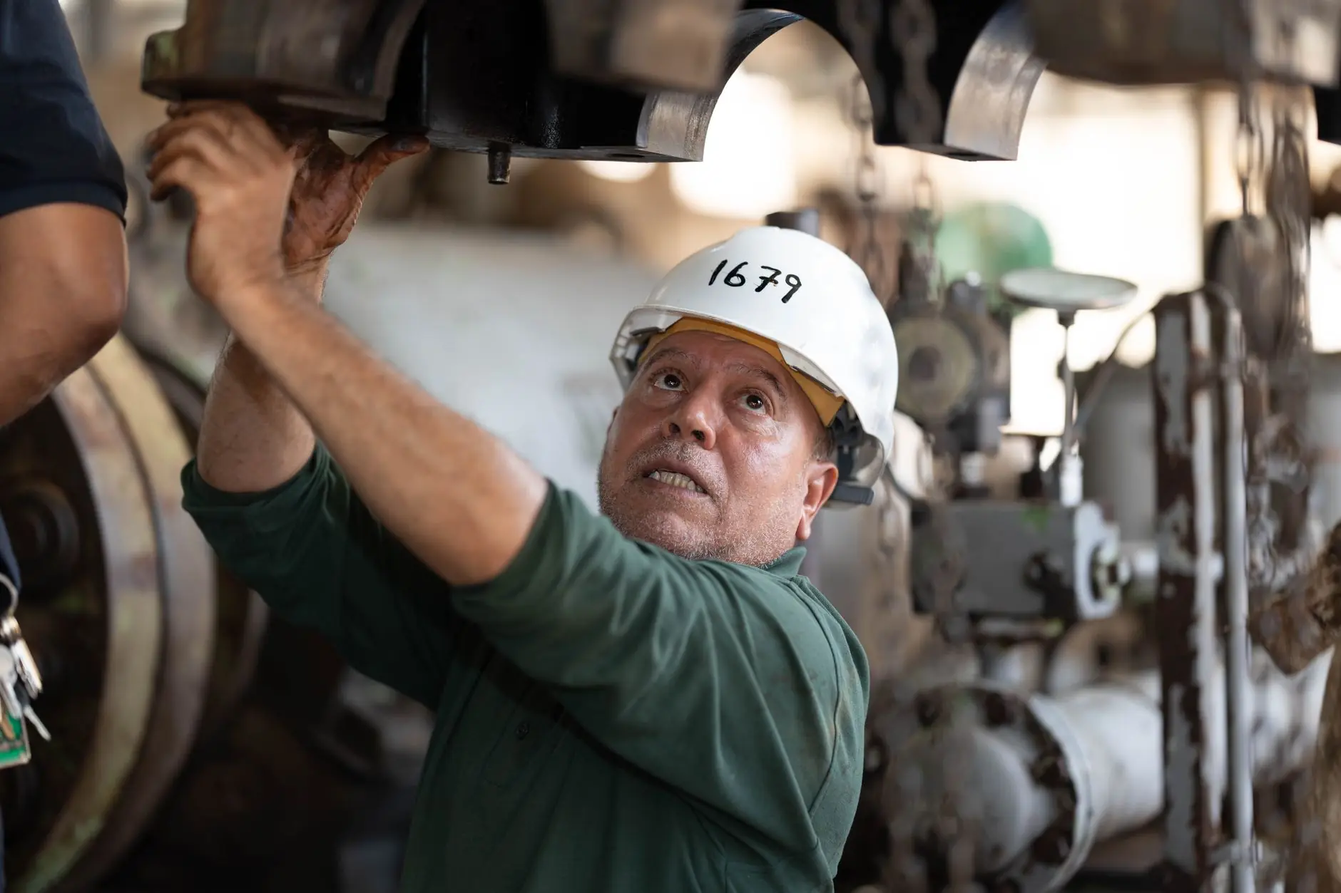 Technician servicing valves and pipework